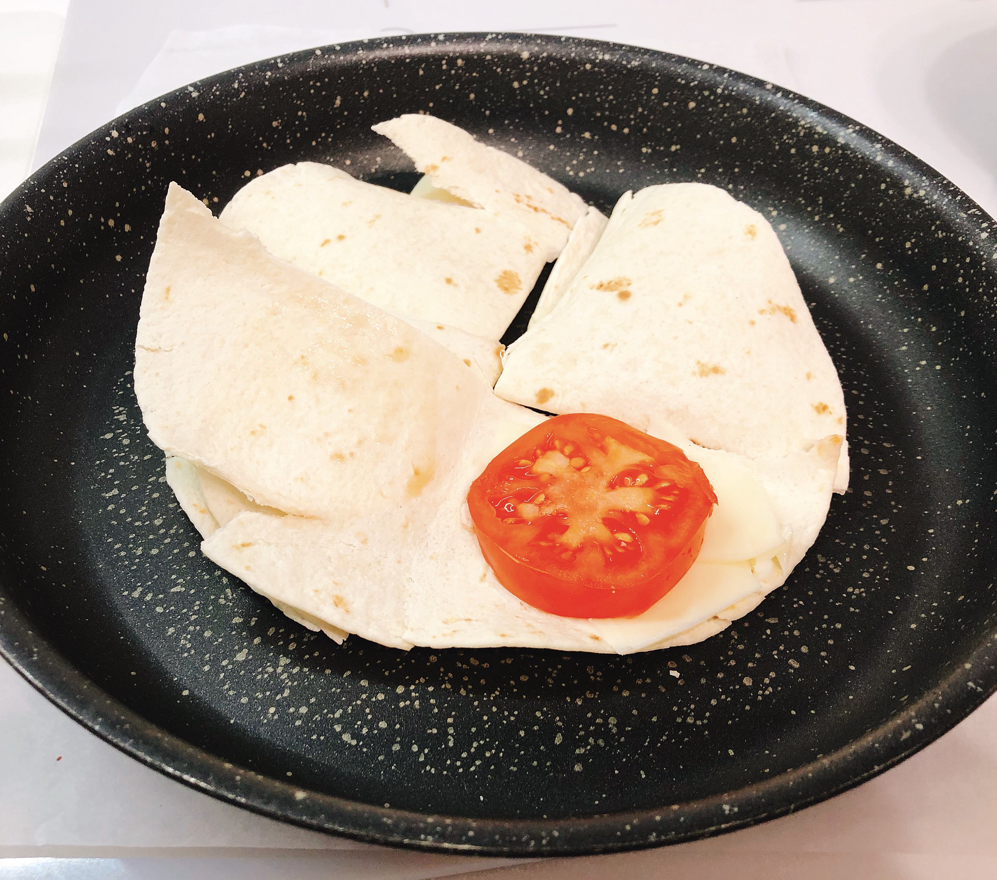 Fried tortilla with tomatoes