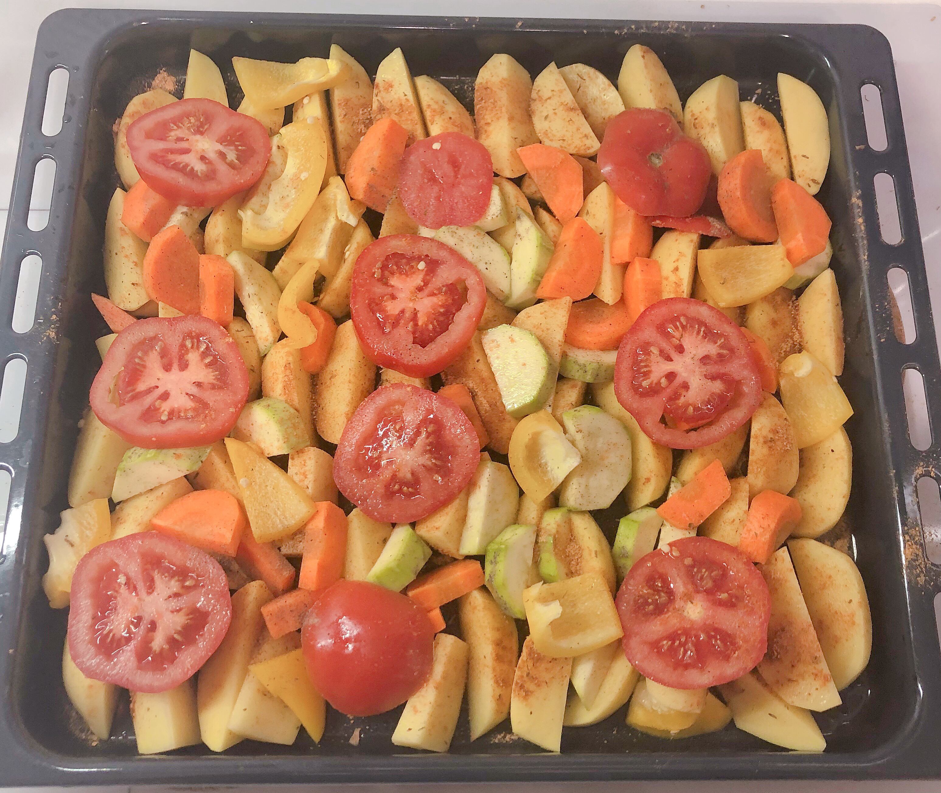Potato slices with vegetables are ready for baking