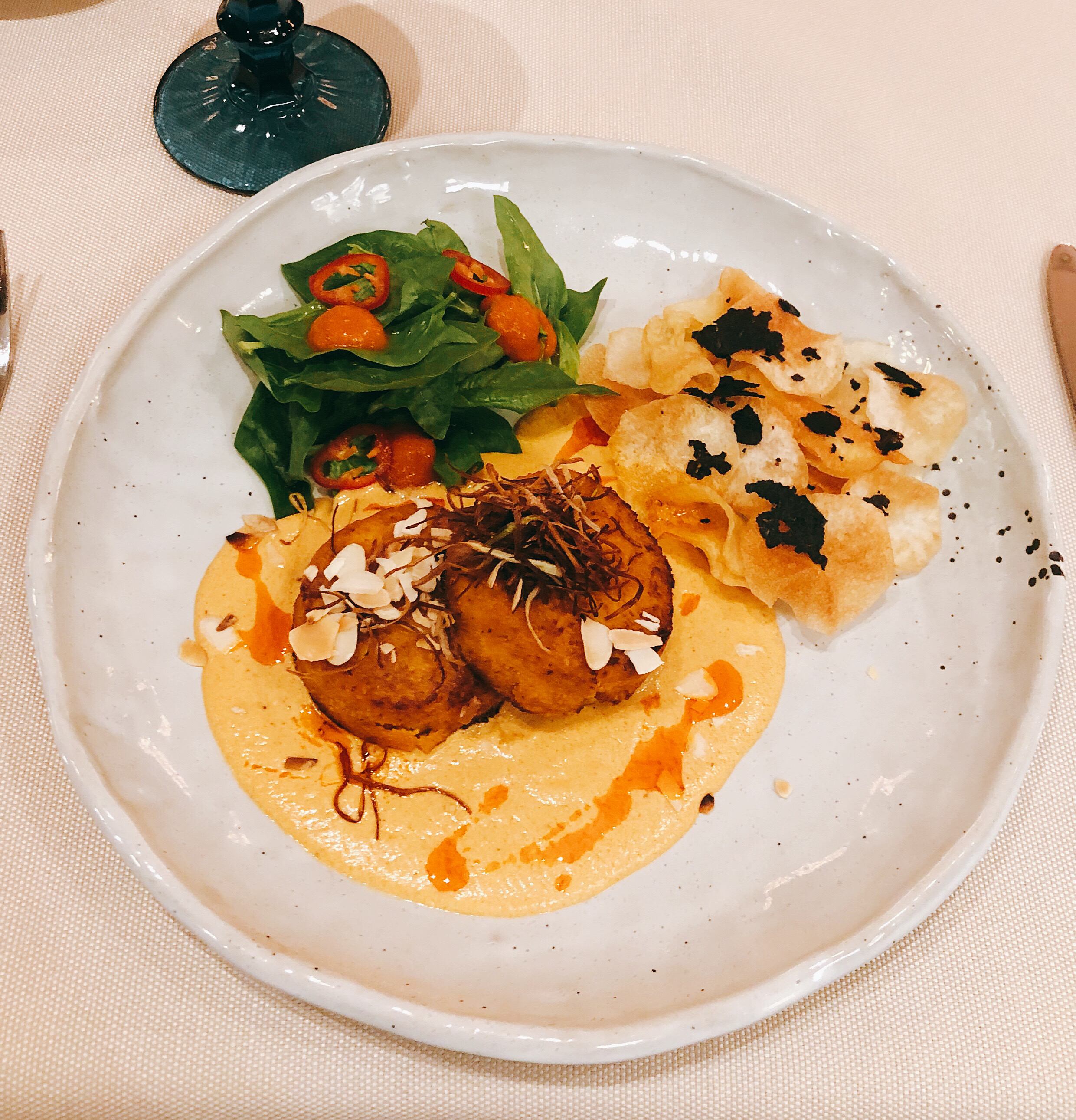 Served crab cakes with vegetables and chips