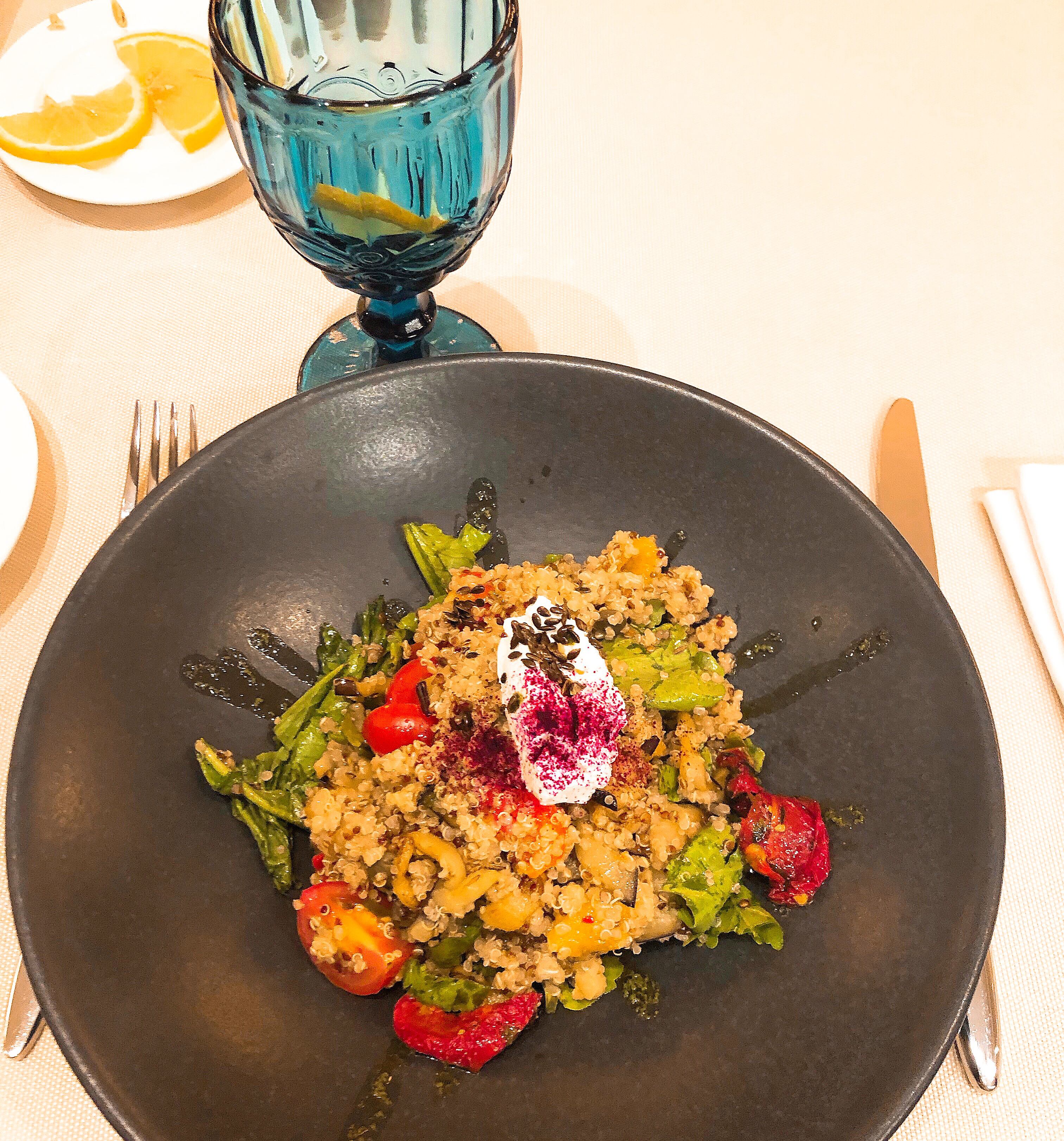 Served warm salad with quinoa, vegetables and cheese