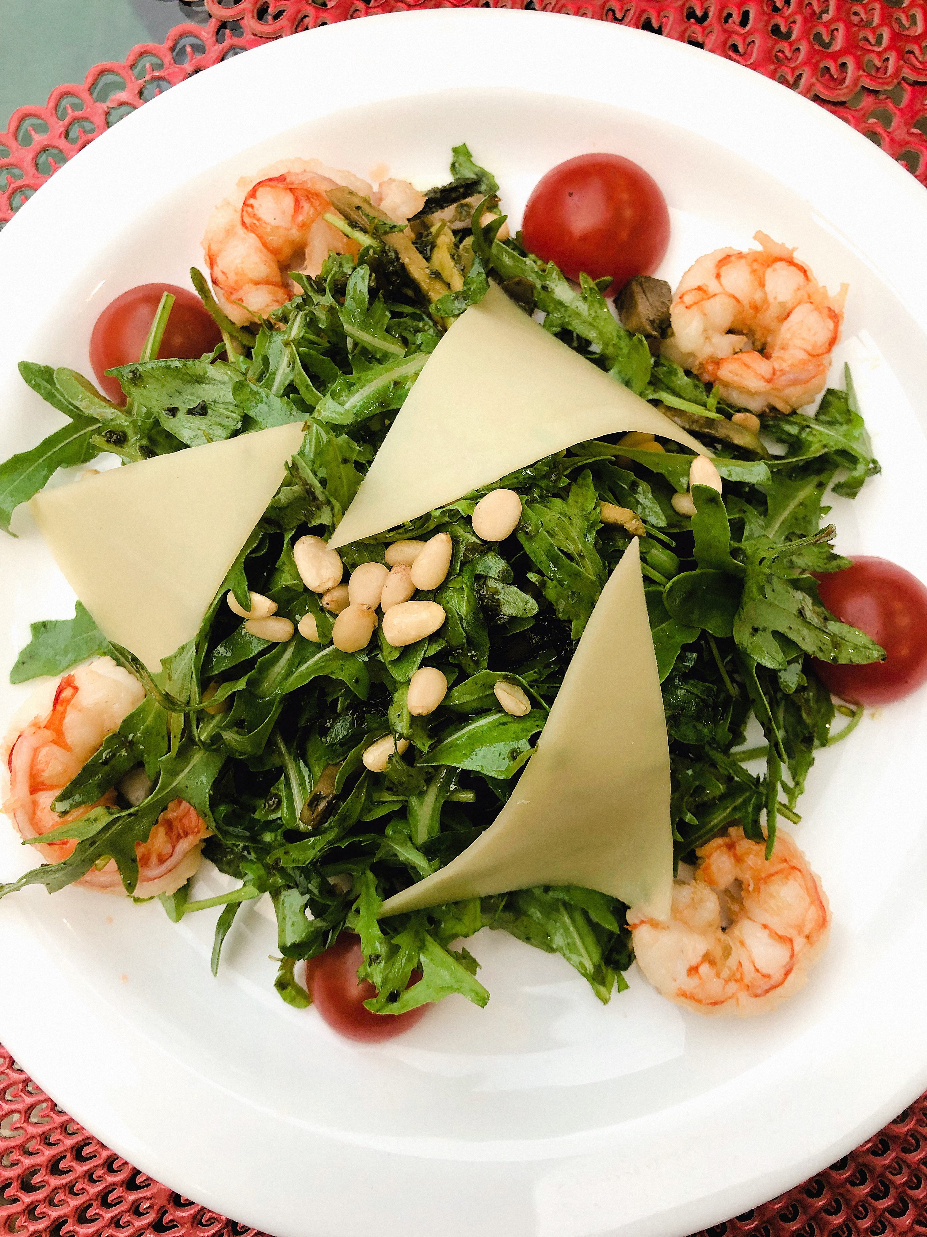 Served Shrimp salad with pine nuts and cheese