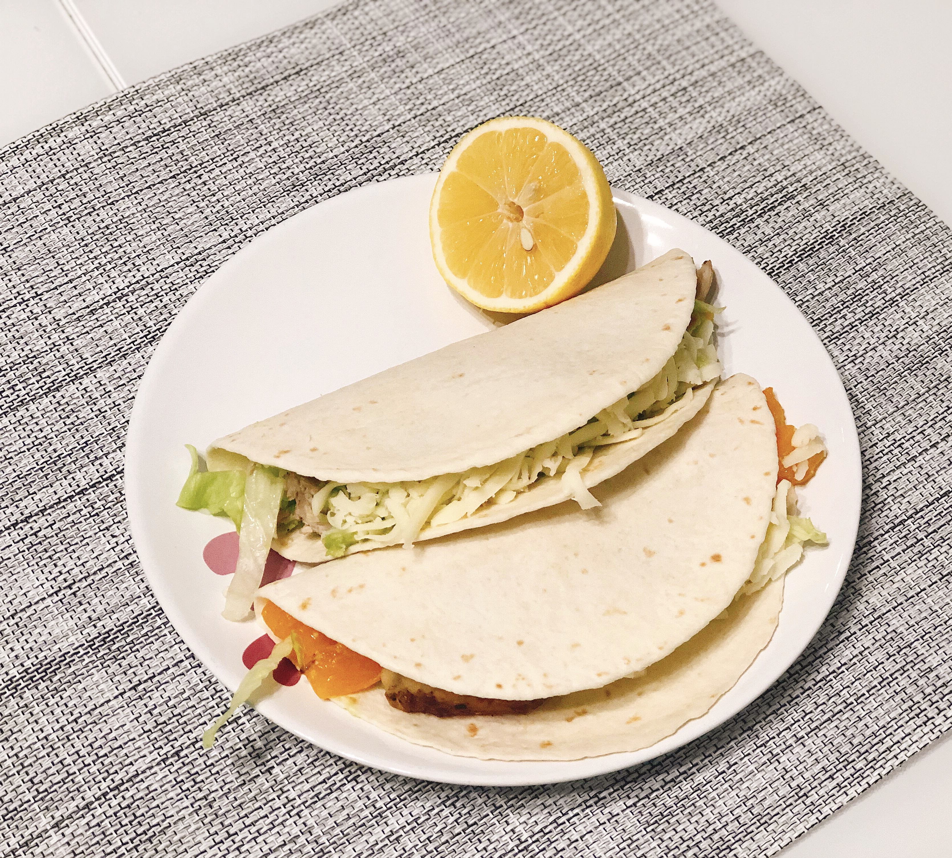Serve tacos with lemon slice for decoration