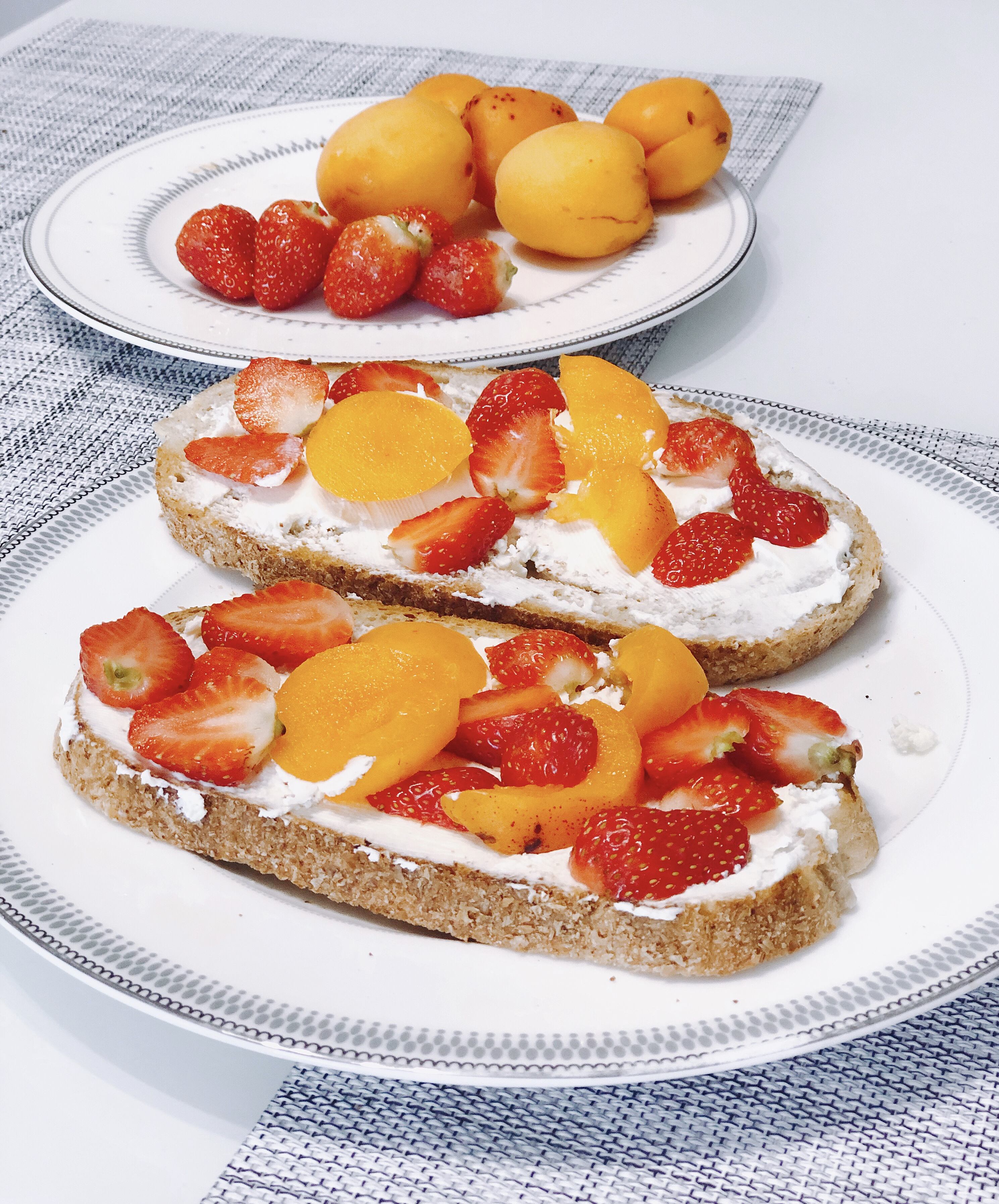 Strawberry and apricot toast with cream cheese for breakfast